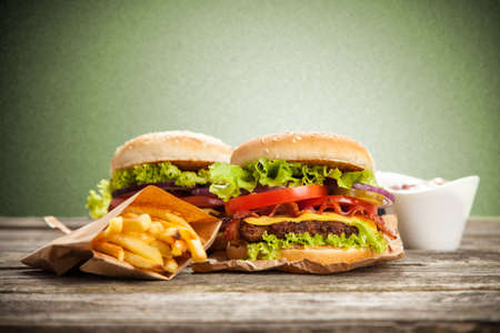 Delicious hamburger and french fries on wooden backgroundの写真素材