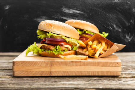 Delicious hamburger and french fries on wooden backgroundの写真素材