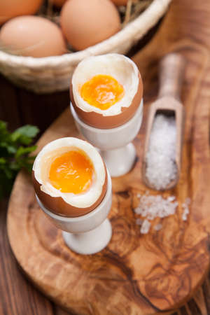 Boiled eggs on a wooden background.の写真素材