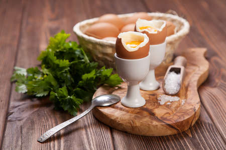 Boiled eggs on a wooden background.の写真素材