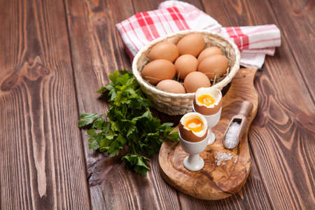 Boiled eggs on a wooden background.の写真素材