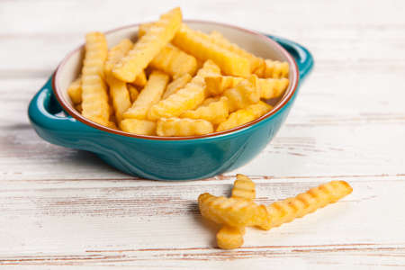 Bowl of french fries on old wood backgroundの写真素材