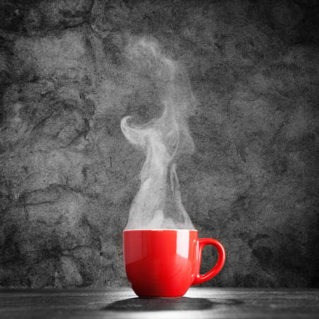 Steaming coffee cup on dark backgroundの写真素材