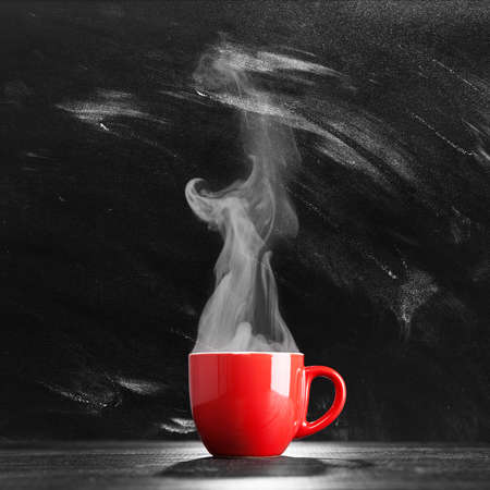 Steaming coffee cup on dark backgroundの写真素材