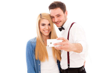 Young beautiful hipster couple making a selfie