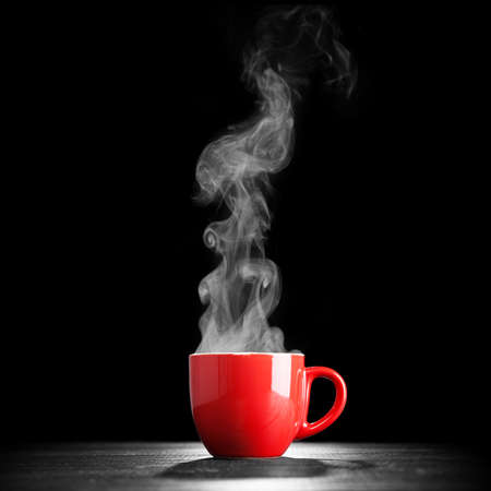Steaming coffee cup on dark backgroundの写真素材