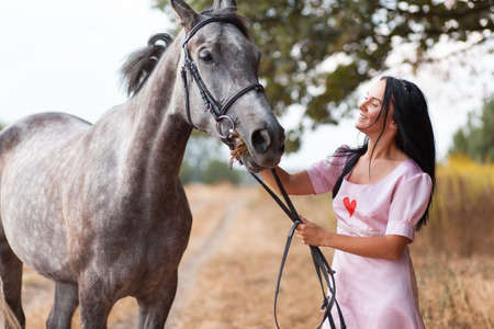 Young beautiful woman with a horseの写真素材