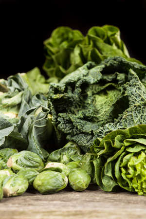 Assortment of green vegetables on wooden surfaceの写真素材