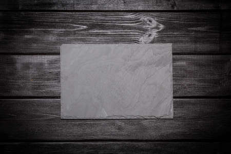 Stone board with different spices on wooden surfaceの写真素材