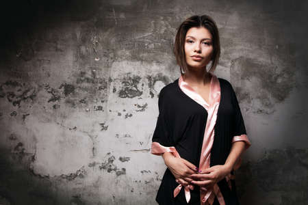 Young woman studio portrait over gray backgroundの写真素材