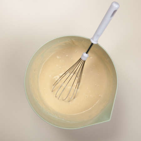 Preparing batter for pancakes in a bowlの写真素材