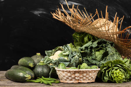 Assortment of green vegetables on wooden surfaceの写真素材