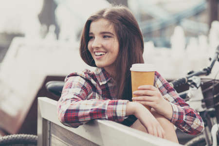 Young woman drinking coffee on a bicycle trip.の写真素材