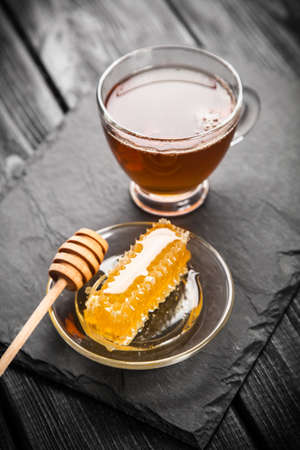 Tea and honey on dark backgroundの写真素材