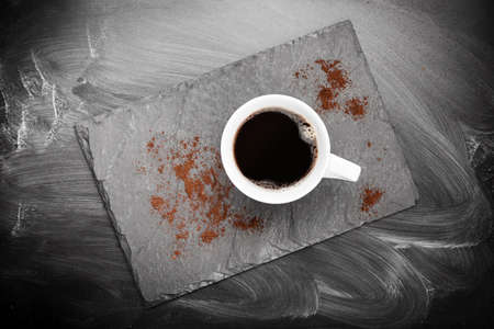 Cup of hot coffee on stone board