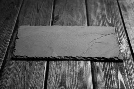 Black slateboard on dark wood background
