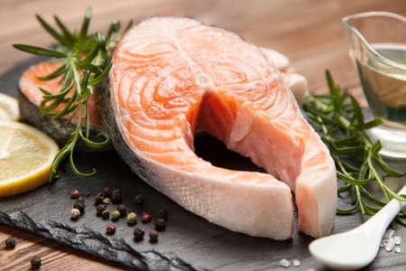 Fresh salmon slice on old woodの写真素材