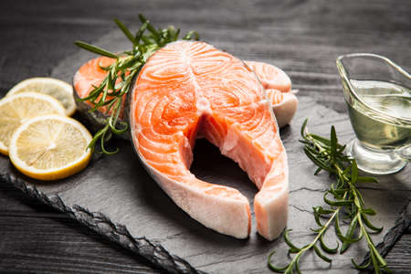 Fresh salmon slice on old woodの写真素材