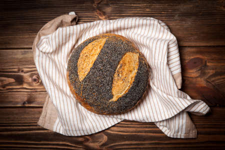 Freshly baked bread assortment on wooden surfaceの写真素材