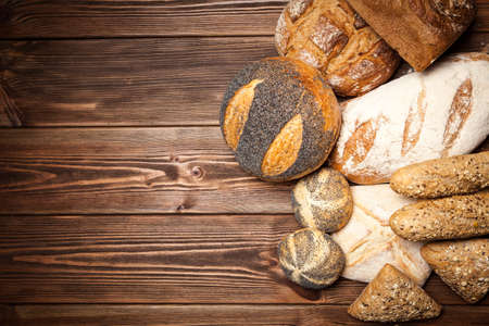 Freshly baked bread assortment on wooden surface