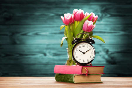 Vintage alarm clock close-up on wooden surfaceの写真素材