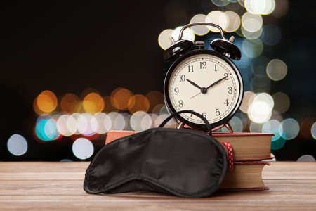 Vintage alarm clock and a sleep maskの写真素材