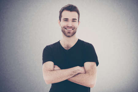 Portrait of a young man on grey backgroundの写真素材