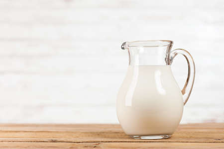 Milk jar on a wooden tableの写真素材