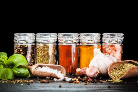 Set of different herbs and spice on dark backgroundの写真素材