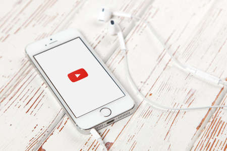 WROCLAW, POLAND - APRIL 12, 2016: Apple iPhone SE smartphone with Youtube app on screen