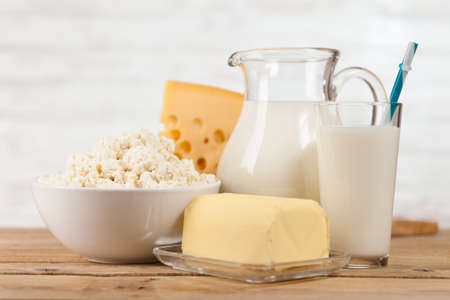 Milk and dairy products on a wooden tableの写真素材