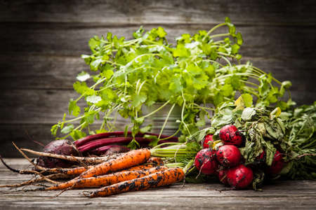 Fresh organic vegetables on wooden surfaceの写真素材