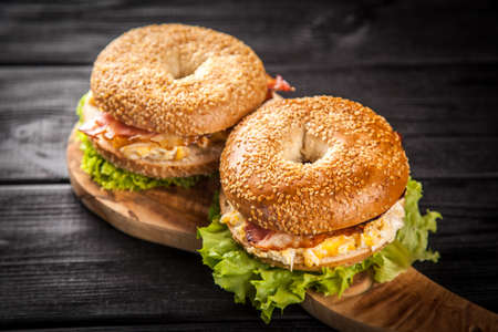 Bagel with bacon and egg for breakfastの写真素材
