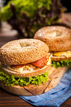 Bagel with bacon and egg for breakfastの写真素材