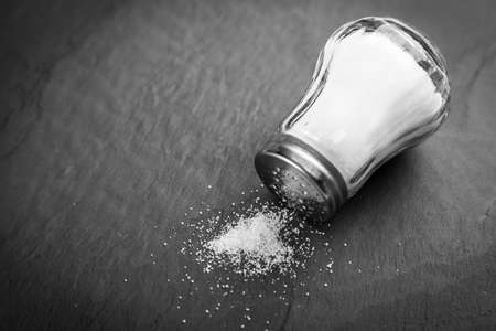 Salt shaker on a slate boardの写真素材