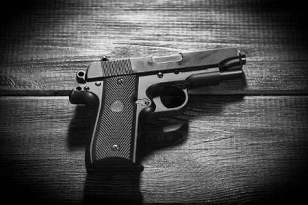 Airsoft gun replica on dark background.の写真素材