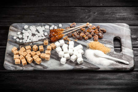 Different types of sugar on black backoundの写真素材