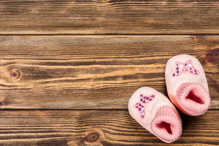 Baby clothes on wooden background.の写真素材