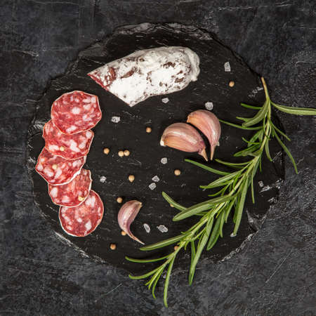 Traditional italian salami on dark background