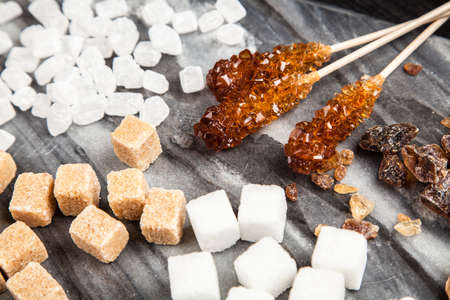 Different types of sugar on black backoundの写真素材