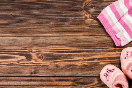 Baby clothes on wooden background.の写真素材