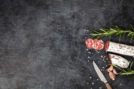 Traditional italian salami on dark backgroundの写真素材