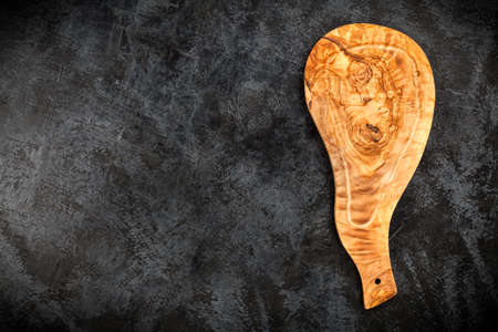 Olive wood cutting board on black backgroundの写真素材