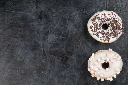 DIfferent tasty donuts on dark backgroundの写真素材