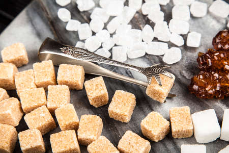 Different types of sugar on black backoundの写真素材