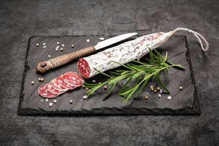 Traditional italian salami on dark background
