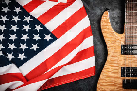 Electric guitar and USA flag on grey backgroundの写真素材