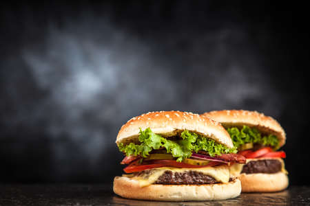 Delicious grilled burger on black backgroundの写真素材
