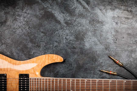Electric guitar with natural wood finish on grey backgroundの写真素材