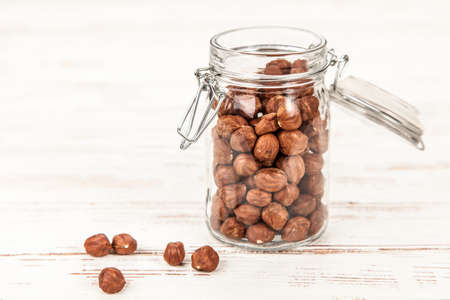 Closeup of hazelnuts in a glass containerの写真素材